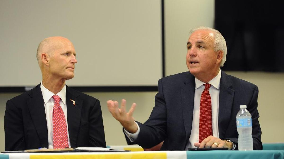 Gov. Rick Scott, left, along with Miami-Dade county mayor Carlos Gimenez, speaks to local officials in June about ways to combat the spread of the Zika virus