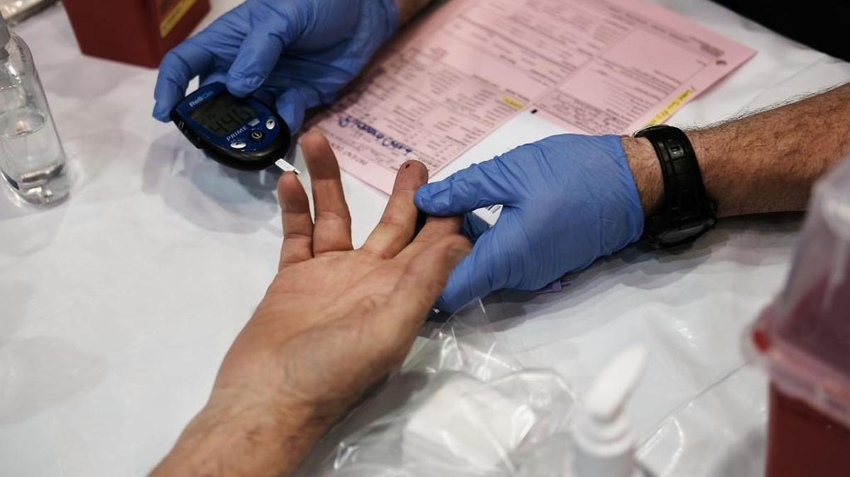 A man has his blood tested at the Remote Area Medical (RAM) mobile dental and medical clinic on June 10, 2017 in Olean, New York. RAM provides free medical care through mobile clinics in underserved, isolated, or impoverished communities around the country and world.