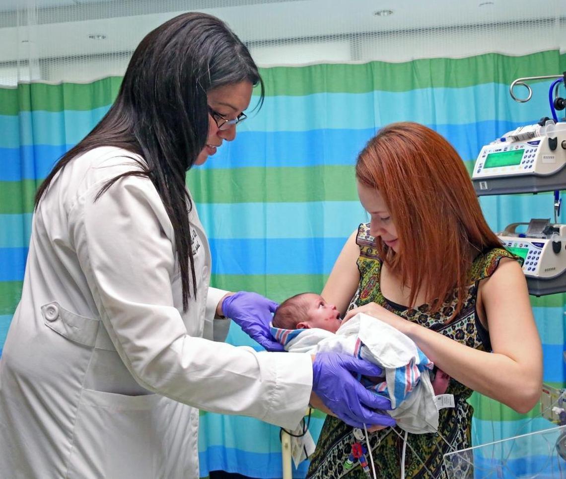 Dr. Darline Santana-Acosta, left, hands baby Amelia Pieve Silvagnoli to her mother, Christine Silvagnoli, at Nicklaus Children’s Hospital in Miami on Monday, Oct. 2, 2017. Amelia is one of three infants needing heart surgery who were evacuated from Puerto Rico to Miami in a rescue effort coordinated by Dr. Santana-Acosta, whose contacts on the island reached out to her for help after Hurricane Maria wracked the hospital that was caring for the infants.
