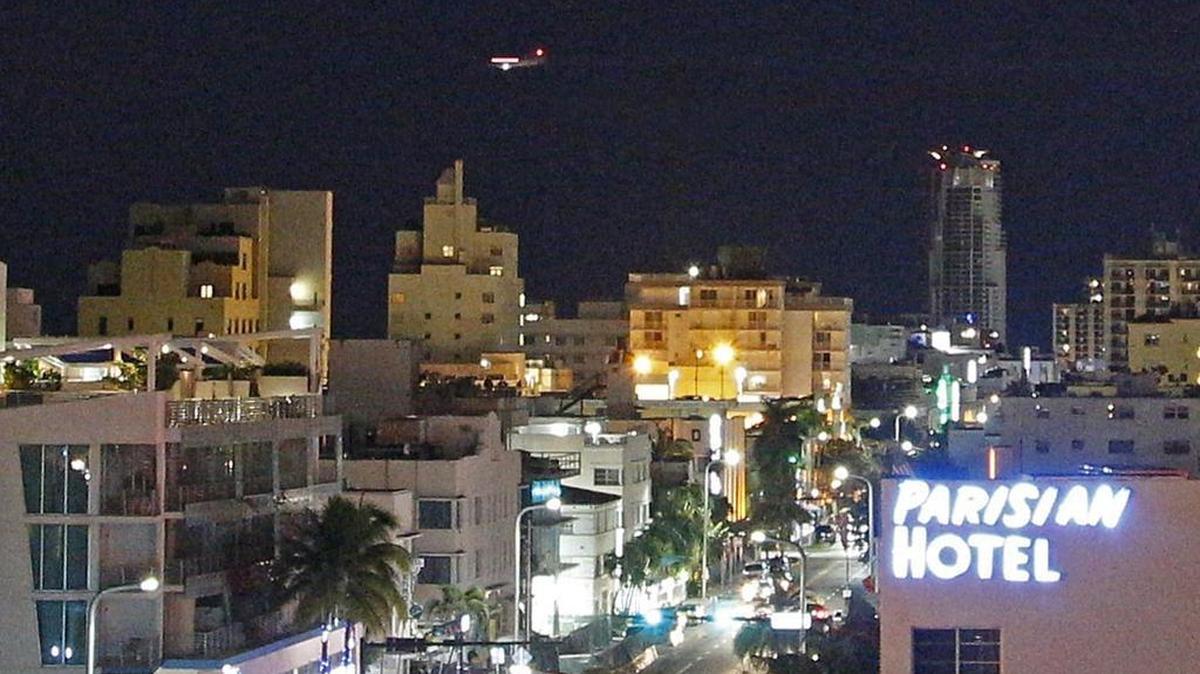 A plane flies over South Beach during aerial spraying of Naled to fight against the spread of the Zika virus by mosquitoes on Sunday, September 18, 2016.