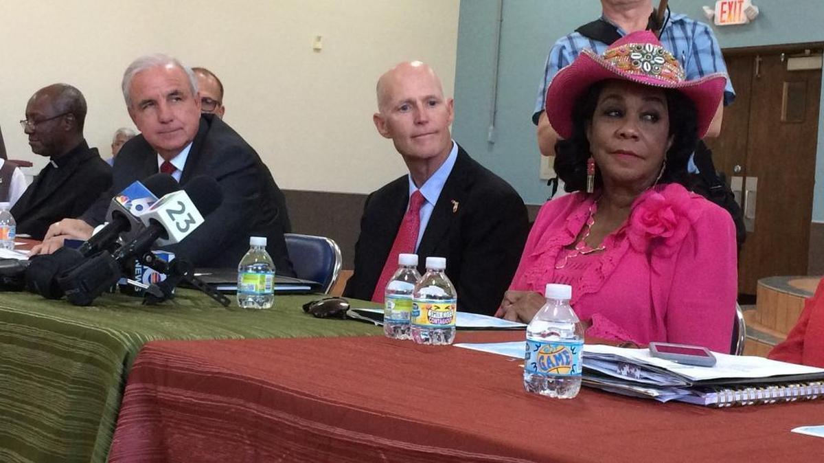 From left, Miami-Dade Mayor Carlos Gimenez, Florida Gov. Rick Scott and U.S. Rep. Frederica Wilson of Florida meet to discuss anti-Zika efforts at St. Mary’s Cathedral School in Miami. The school is located within a one-square-mile area of the Little River neighborhood where state officials said mosquitoes are spreading Zika.
