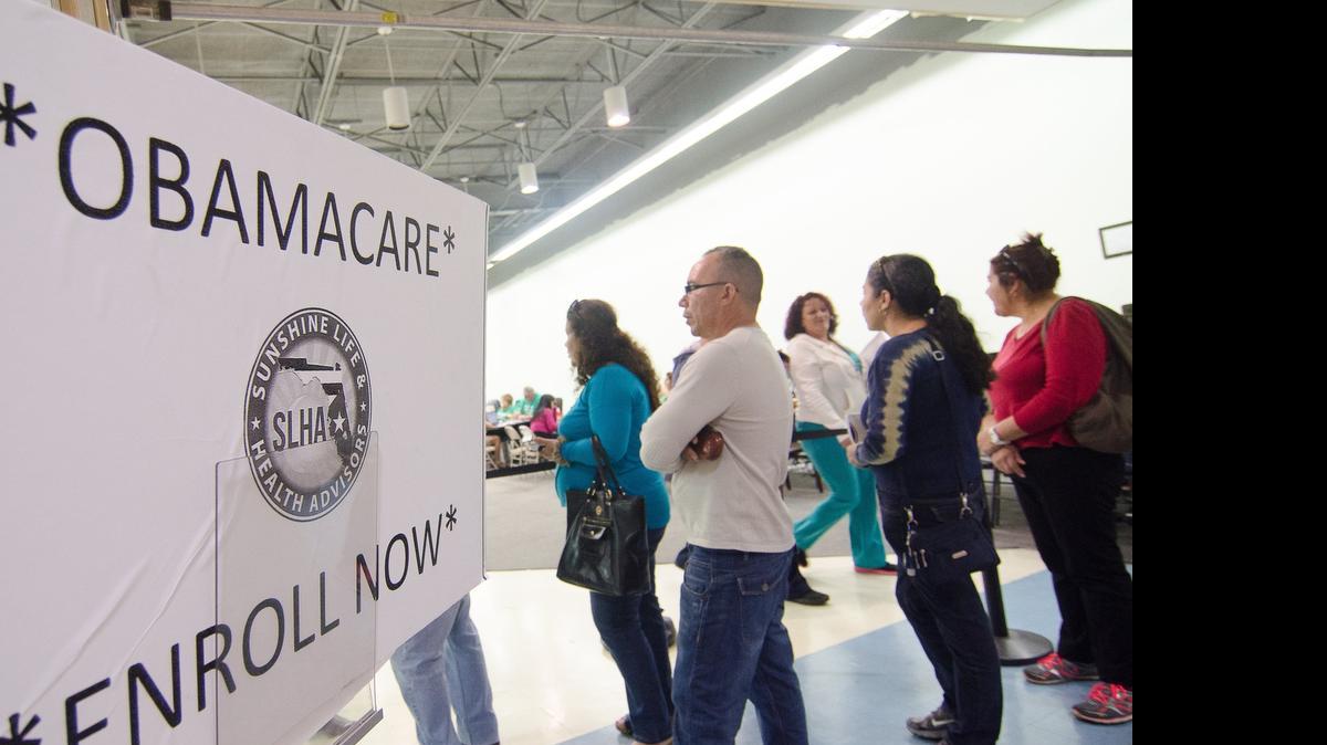 
Applicants line up outside the Sunshine Life and Health Advisors storefront in the Mall of the Americas in December. Many consumers have reported losing the financial assistance to lower their monthly premiums after enrolling in a plan because the marketplace has struggled to resolve inconsistencies in documentation, particularly regarding income. 
