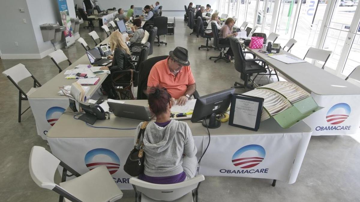 The deadline is Tuesday for consumers to enroll in a health plan with coverage that begins on Jan. 1. In this photograph, Madelaine Carrazana 46, discusses Obamacare plans with insurance agent Arturo Aguiar at the Univista Insurance agency branch on Flagler Street in February 2015.