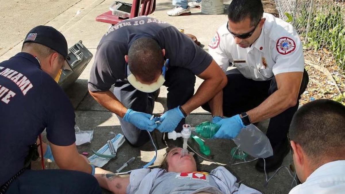 Captain Tony Milan, EMS battalion commander for City of Miami Fire Rescue, upper right, works on a suspected overdose victim with his crew on Thursday November 17, 2016.