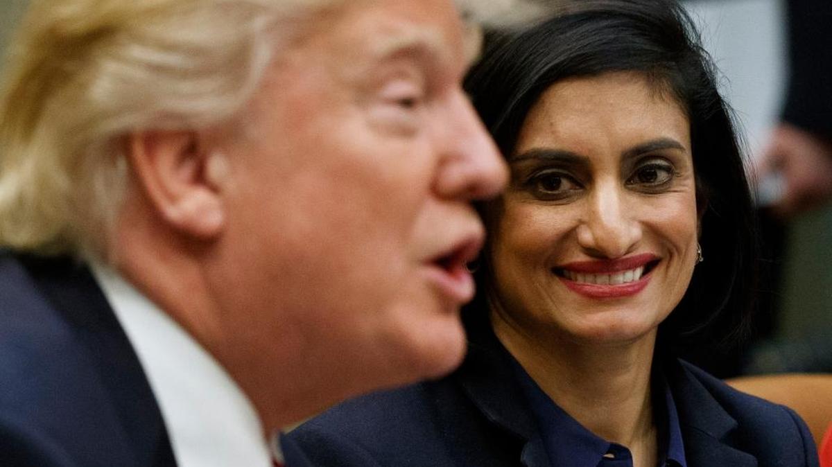In this March 2017 photo, Seema Verma (right), administrator of the Centers for Medicare and Medicaid Services, listens as President Donald Trump speaks during a meeting in the the White House. Among the major changes considered for Medicaid is spending caps and work requirements for beneficiaries.