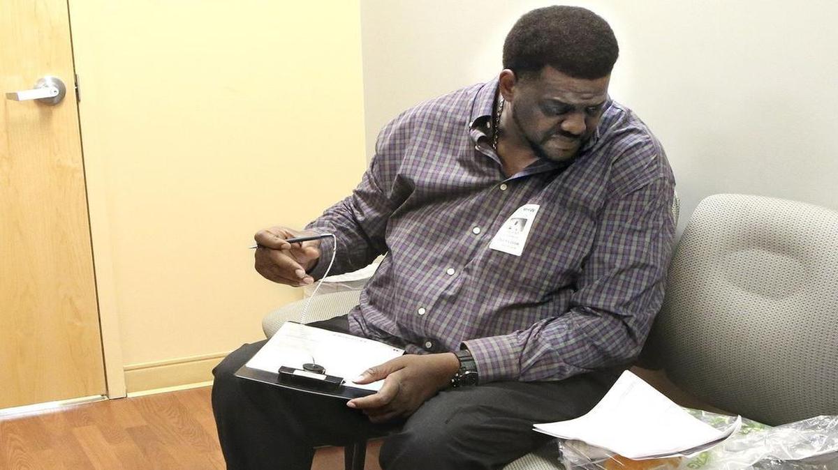 
Vincent Adderly, 46, of Miami Gardens fills out forms in the medical records office at Memorial Hospital West in Pembroke Pines on Thursday, May 28, 2015. He is uninsured and diabetic and was at the hospital following his recent week-long hospitalization there. Part of the big toe on Adderly's right foot had to be amputated. 
