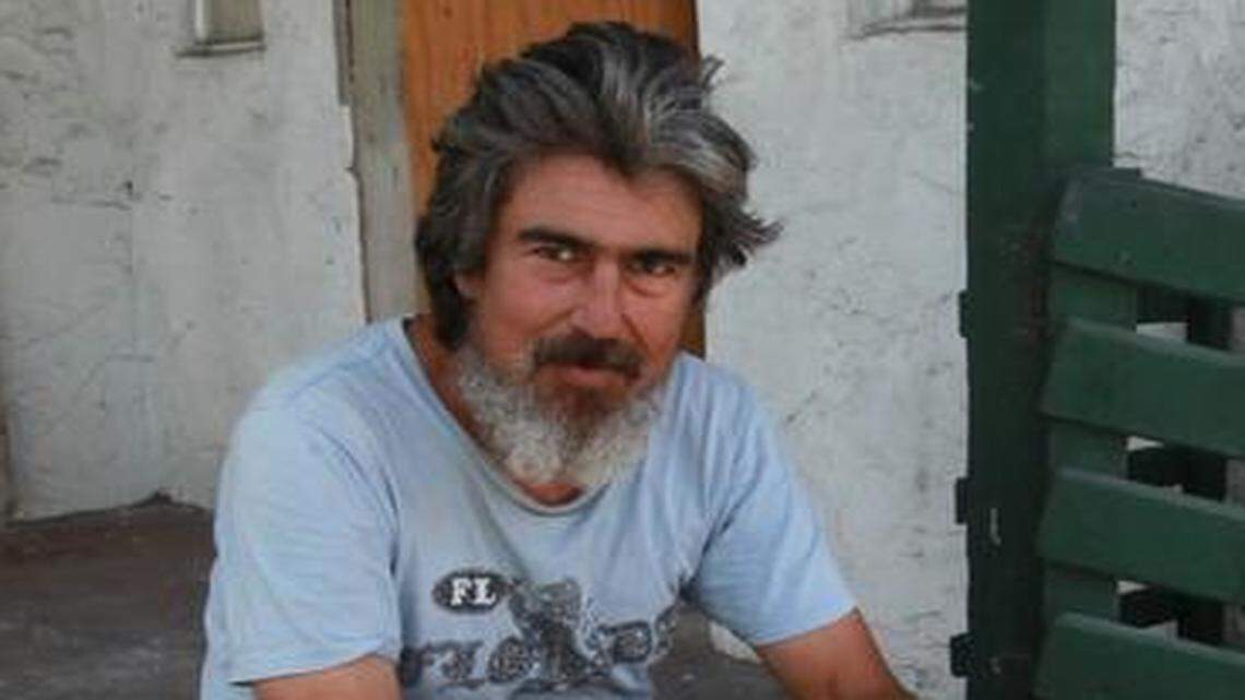 
Eric Schmidt, 51, sits on the steps of the abandoned house where he sleeps.

