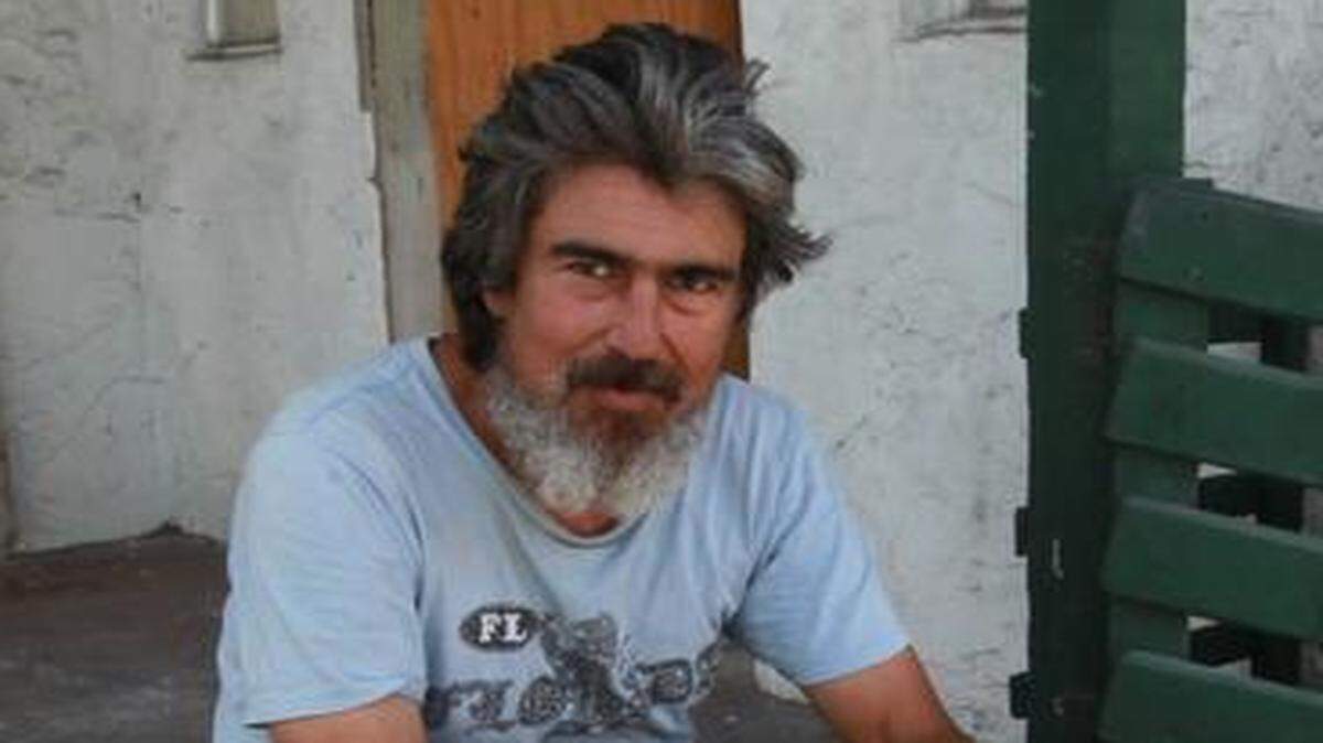 
Eric Schmidt, 51, sits on the steps of the abandoned house where he sleeps.
