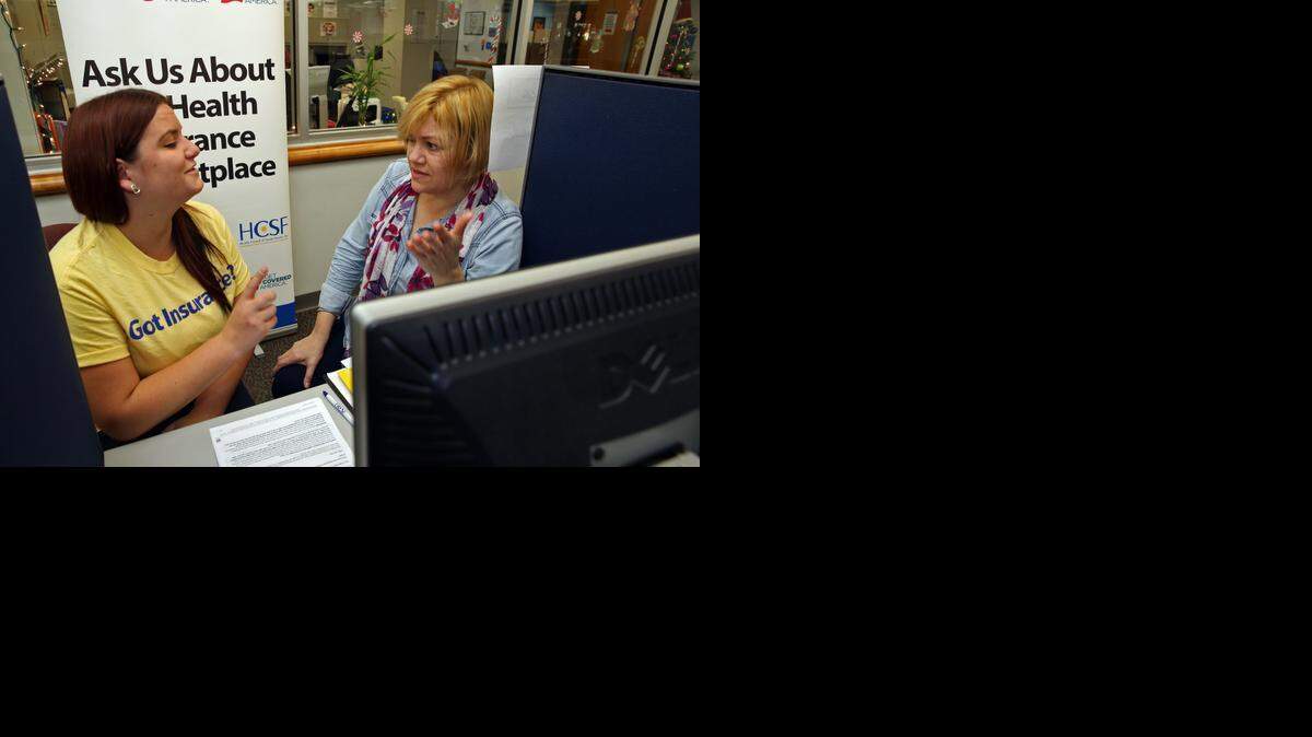 
Helen Shaheen, a navigator with the Health Council of South Florida, helps Dora Welter enroll online for coverage under the Affordable Care Act at Miami Dade College's Kendall campus on Wednesday.
