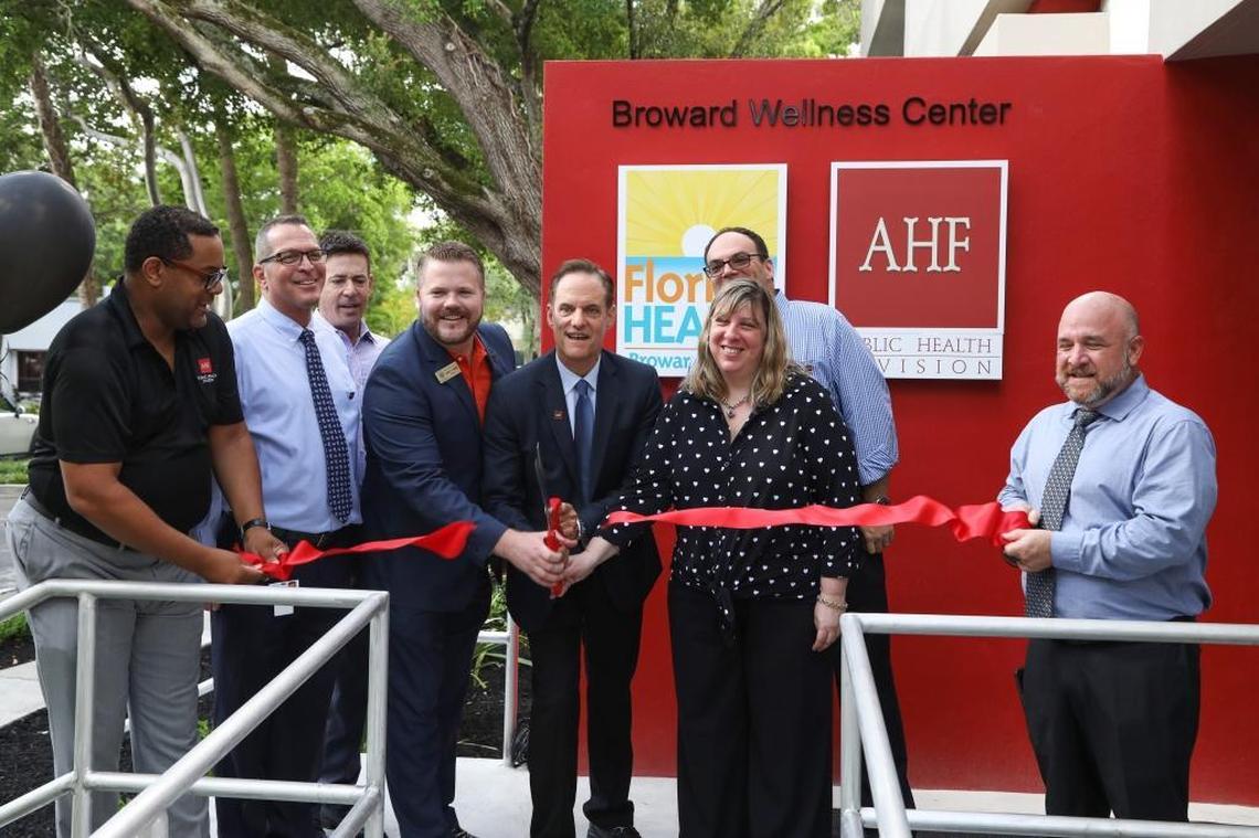Commissioner Justin Flippen, vice mayor of Wilton Manors; Michael Weinstein, president and CEO of AIDS Healthcare Foundation; and Paula Thaqi, director of Florida Department of Health in Broward County cut the a ribbon to symbolize the opening of the new Broward Wellness Center.