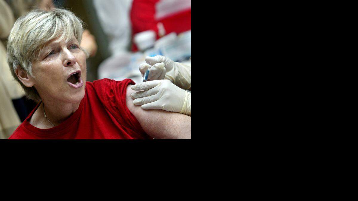 
Libby Michaelson, 66, from Tamarac, reacts while receiving a flu shot several years ago at the Broward Mall in Plantation. 
