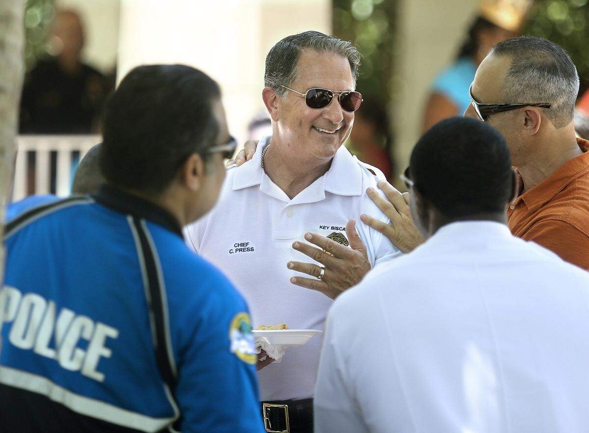 Charles Press, center, remembers a woman and her friend coming to see him when he was Key Biscayne police chief. They were very distraught.