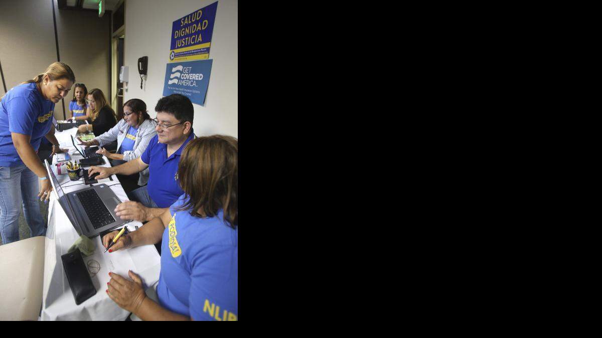 
Dian Y. Alarcon, left, Florida Field Coordinator for the National Latina Institute for Reproductive Health, meets with volunteers as they wait to assist consumers signing up for health coverage under the Affordable Care Act on Nov. 15, 2014 at Palmetto General Hospital in Hialeah. 

