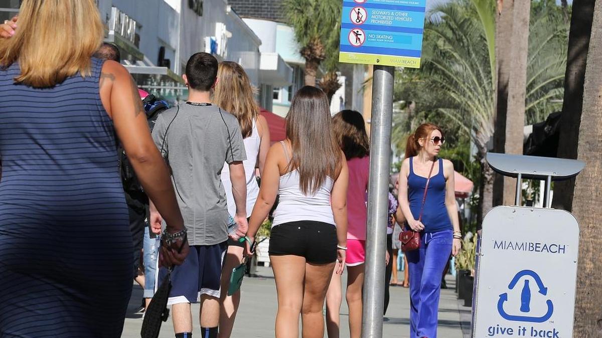 Tourists and residents walk along Lincoln Road as news of some cases of Zika virus were reported in the area.