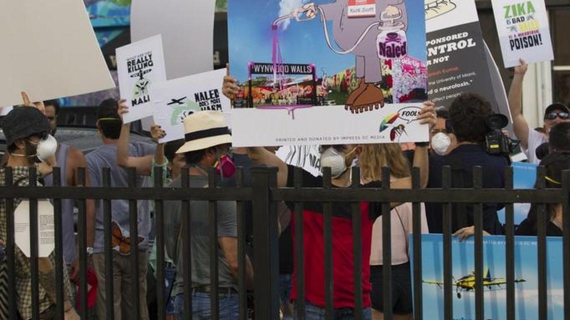 Dozens of people protest the spraying of naled to control mosquitoes in Wynwood during Art Walk in Wynwood, Saturday, Aug. 13.