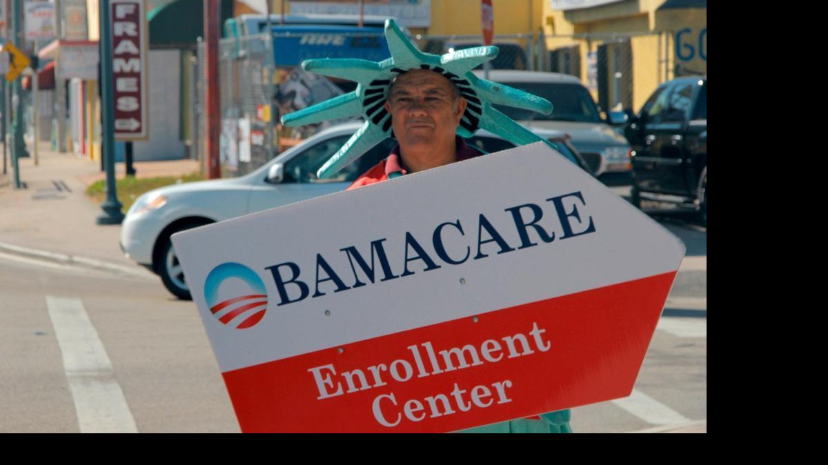 
A man dressed as the statue of liberty advertises for an Affordable Care Act enrollment center on a Little Havana sidewalk during open enrollment this year. More than 1.3 million Floridians receive an average government subsidy of $294 a month to buy health plans under Obamacare -- the most of any state, according to new federal data. 
