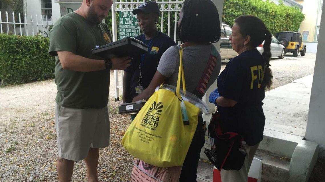 Mariano Corcilli fills out a survey for Department of Health workers who were canvassing his neighborhood Wednesday to talk to residents about Zika virus.