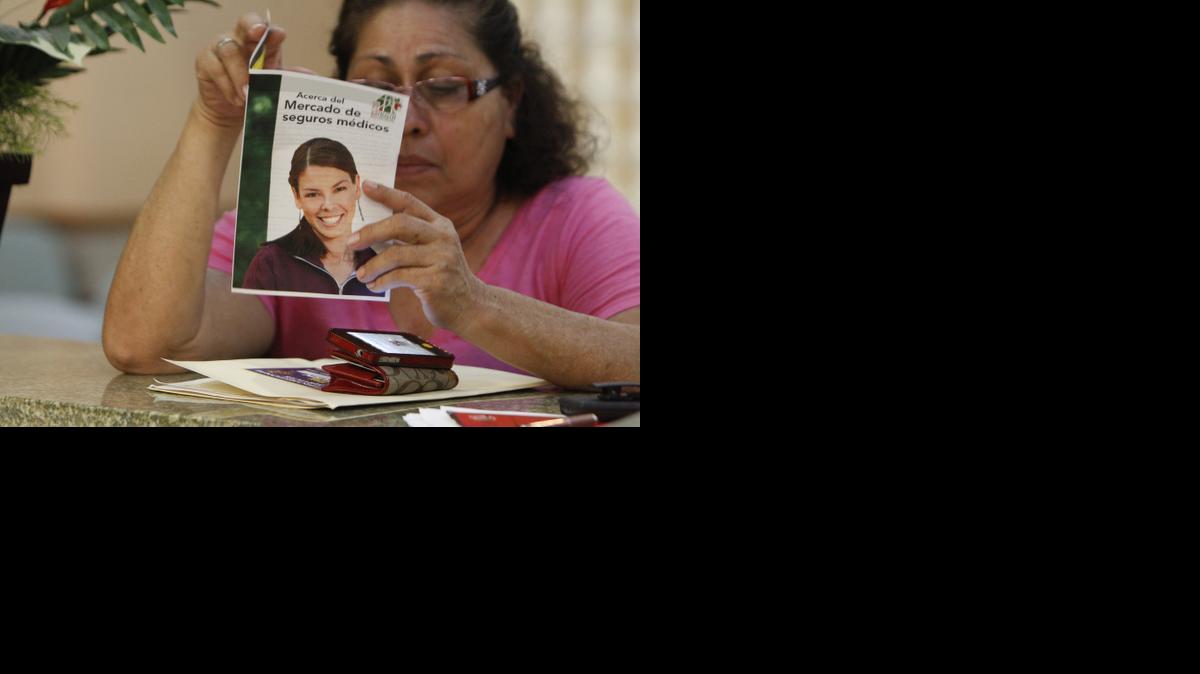 
Adilia Martinez, 57, reads over a pamphlet, written in Spanish, about the different plans offered by the Affordable Care Act. Martinez was at the Jessie Trice Community Health Center last year to speak with counselors who were available to help people sign up for health coverage. This year people can begin signing up on Nov. 15. 

