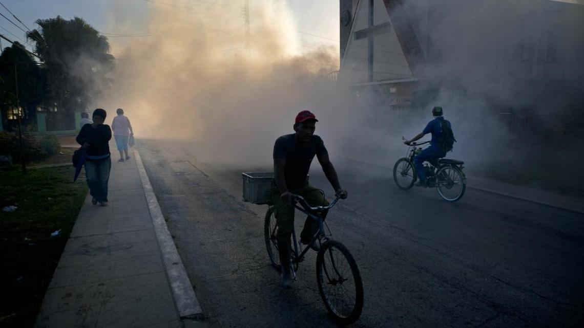 People make their way through fumigation fog, sprayed to kill Aedes aegypti mosquitoes, in Pinar del Rio, Cuba, on March 1. Cuban authorities are fumigating in an attempt to prevent the spread of Zika virus, as well as other similar infectious diseases, including Chikungunya and Dengue. Zika virus has spread rapidly through Central and South America, Mexico and the Caribbean.