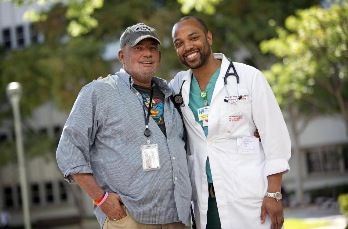 Jose De Lemos, 53, and Dr. Hansel Tookes, a University of Miami medical resident, outside of Jackson Memorial Hospital after a recent visit. De Lemos, who has HIV, is being treated by Tookes. Tookes has been leading the fight to help reduce HIV infections by starting a new needle exchange pilot program in Miami-Dade.