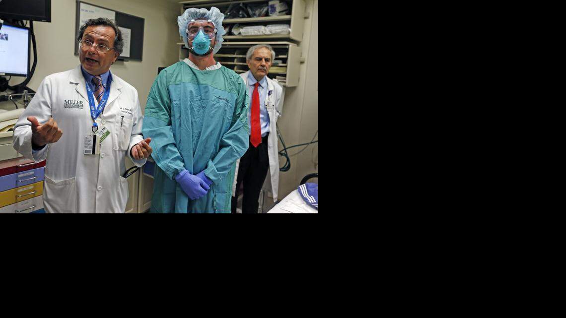 
Infectious disease doctor Dr Jose G Castro decribes the protective gear that UM medical student Christopher Dermarkarian is wearing. The medical team uses the gear when treating patients with infectious diseases, including those at risk of the Ebola virus at Ryder Trauma at Jackson Memorial Hospital.


