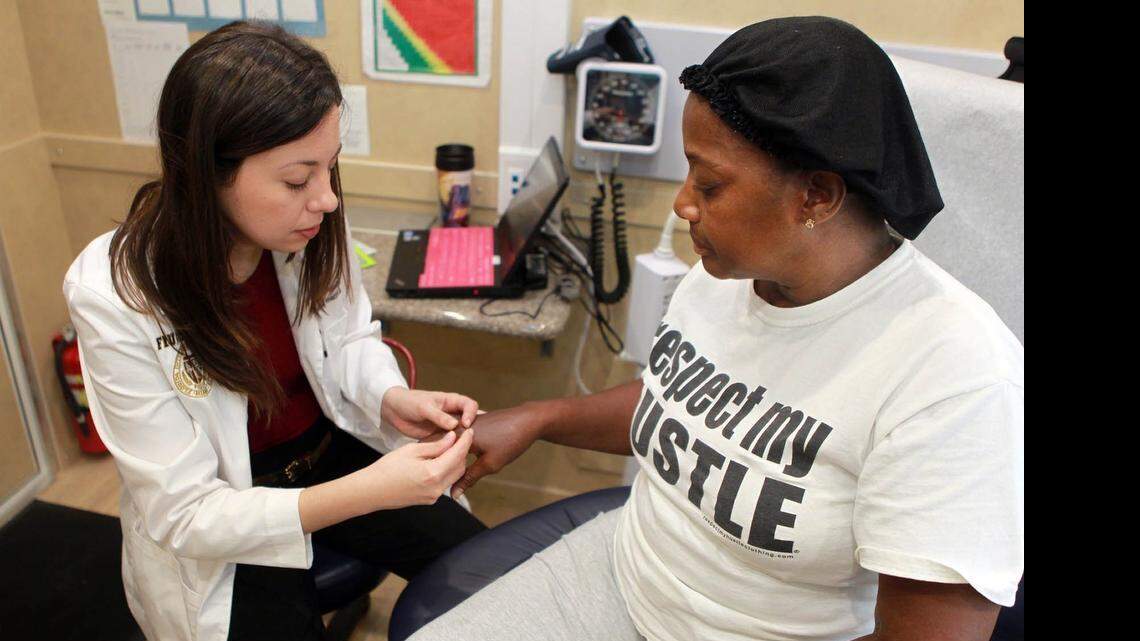 
Dr. Annelys Hernandez, left, checks out Cynthia Louis in Florida International University’s Mobile Health Center.
