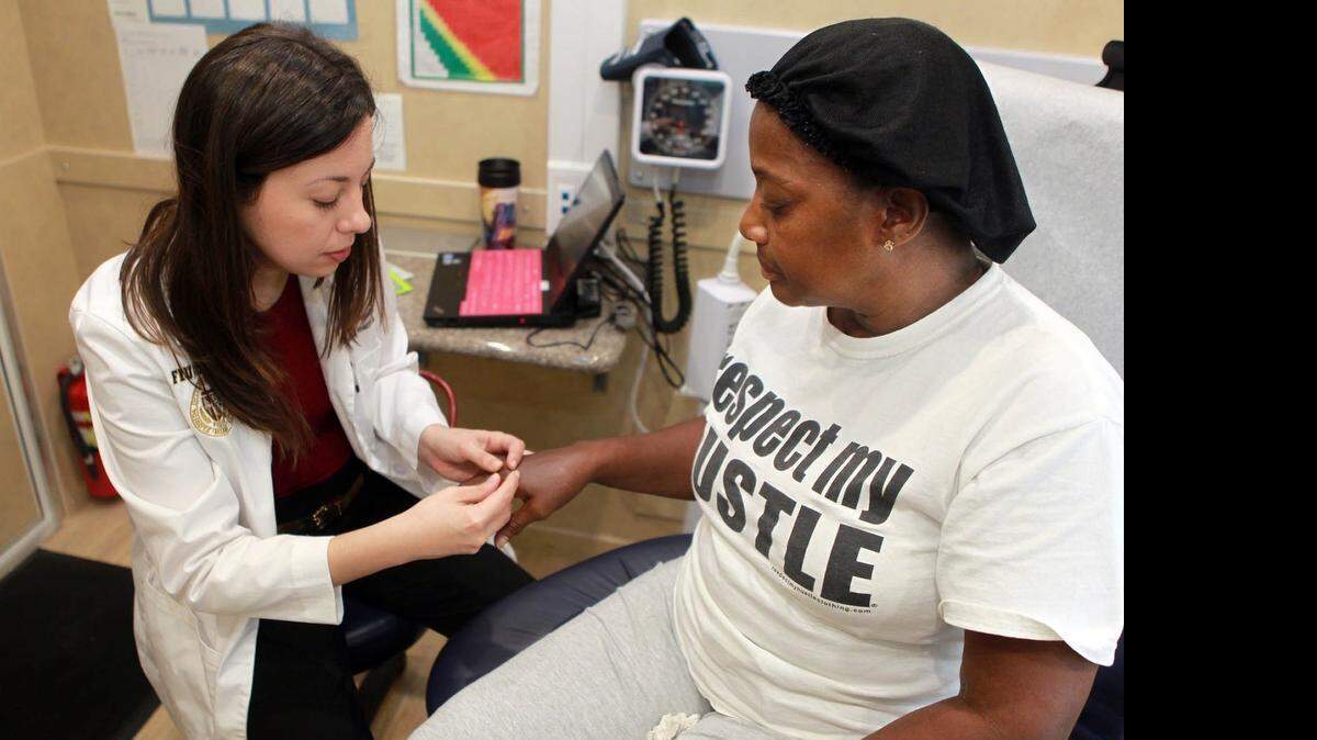 
Dr. Annelys Hernandez, left, checks out Cynthia Louis in Florida International University’s Mobile Health Center.

