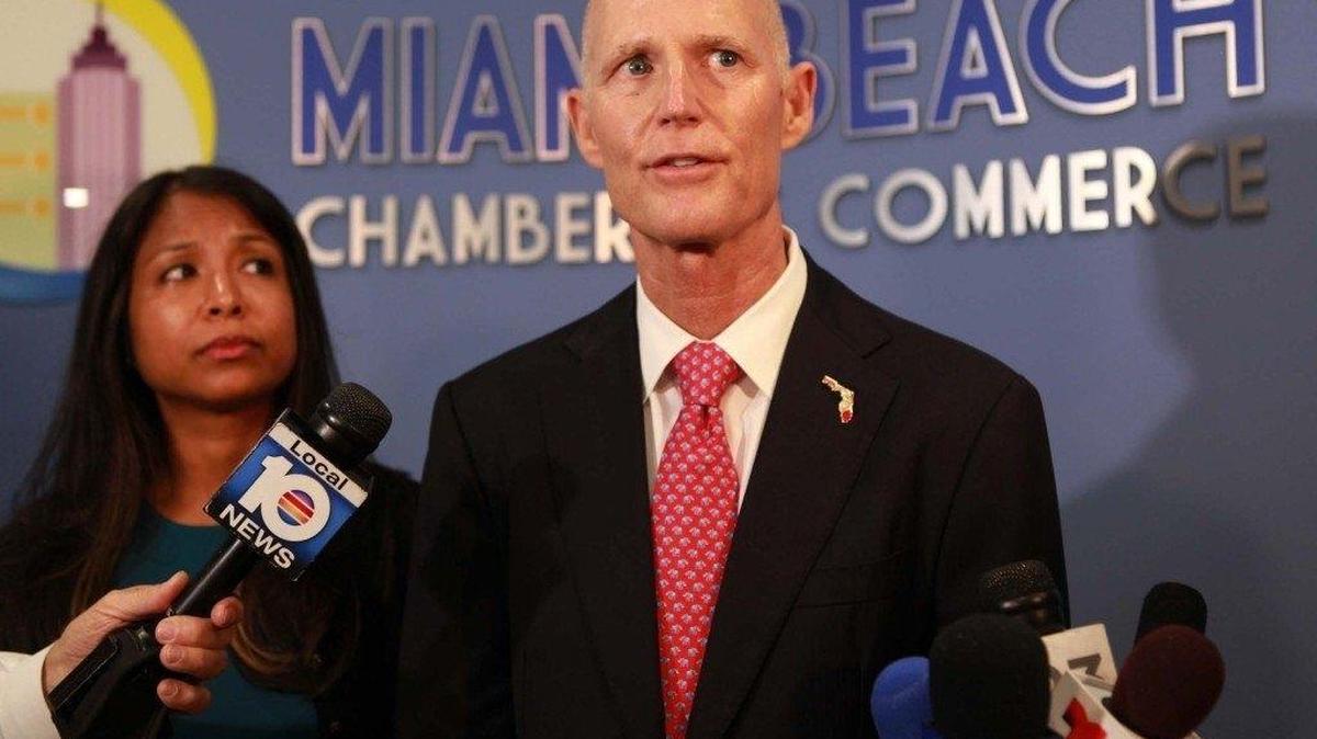 Florida Gov. Rick Scott speaks to media on Aug. 26 from the offices of the Miami Beach Chamber of Commerce following a round table focused on Zika’s impacts to the region’s tourism industry. Florida Surgeon General Celeste Philip (left) also attended the meeting.