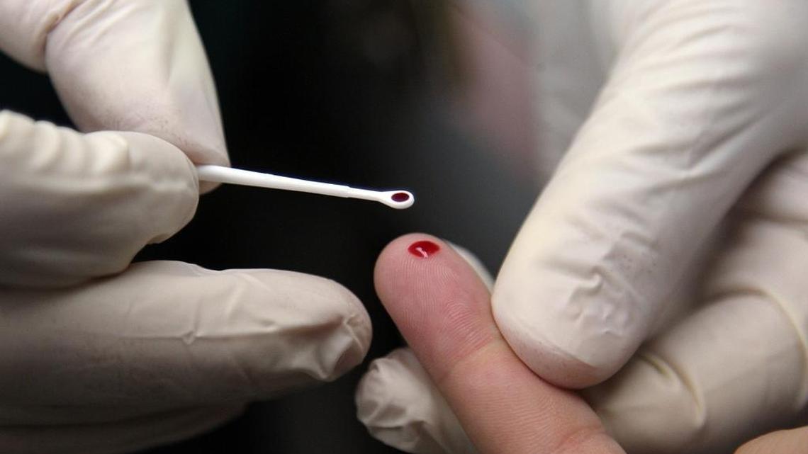A clinical program manager draws a blood sample from a student during a demonstration of teenage HIV testing in November 2015 at Miami Jackson Senior High School.