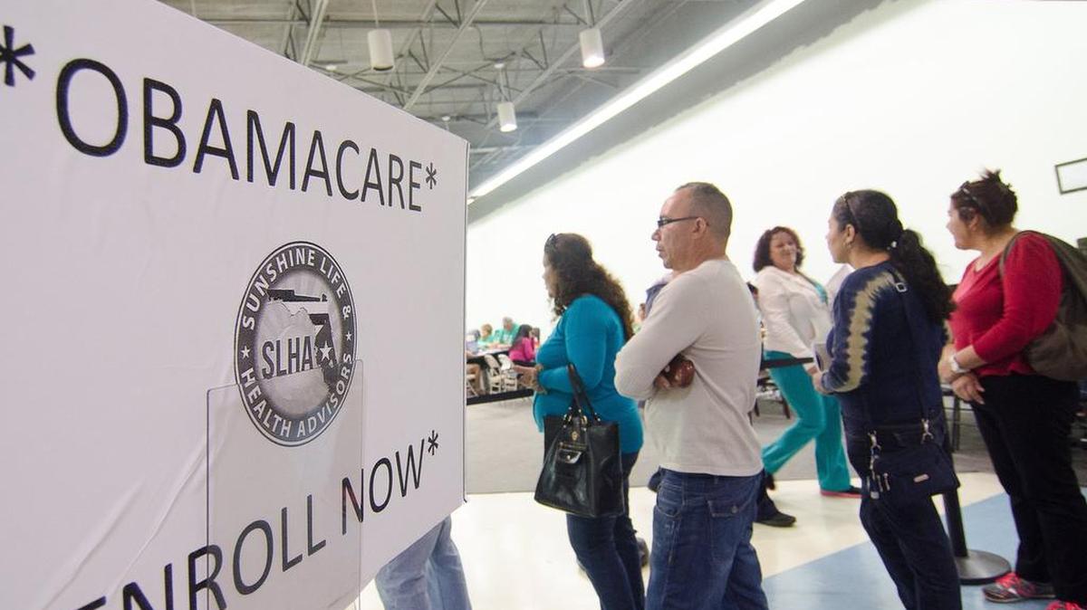 Applicants line outside the Sunshine Life and Health Advisors at a store setup in the Mall of the Americas in Miami in 2014. They were trying to sign up for insurance coverage under the Affordable Care Act.