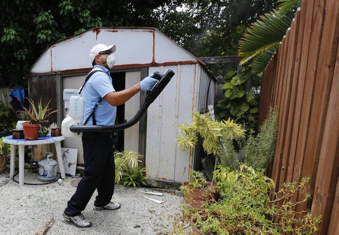 Miami-Dade County inspector Carlos Lanzas sprays a larvicide treatment at a home in South Dade in this May 2017 photo. Miami-Dade County has ramped up efforts to control the urban mosquito species that last year spread the Zika virus. Workers have been applying larvicide year round, an effective tool to stop breeding.