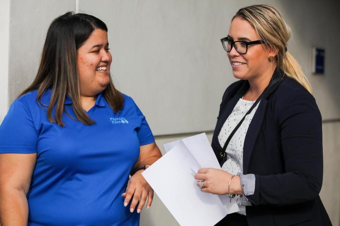 Florida Blue representative Claribel Gonzalez (Left) speaks with Maricely Vazquez Rodriguez (Right) about open enrollment for Affordable Care Act coverage, which begins on Nov. 1. Gonzalez and Rodriguez met at Miami Dade College’s Kendall campus on Oct. 25 as Florida Blue gears up outreach efforts to consumers who are confused and uncertain about the status of the health law known as Obamacare.