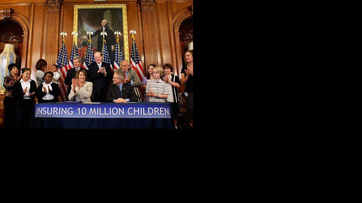 
Democratic members of Congress applaud shortly after signing legislation for the Children's Health Insurance Program (CHIP) legislation at the U.S. Capitol September 28, 2007.


