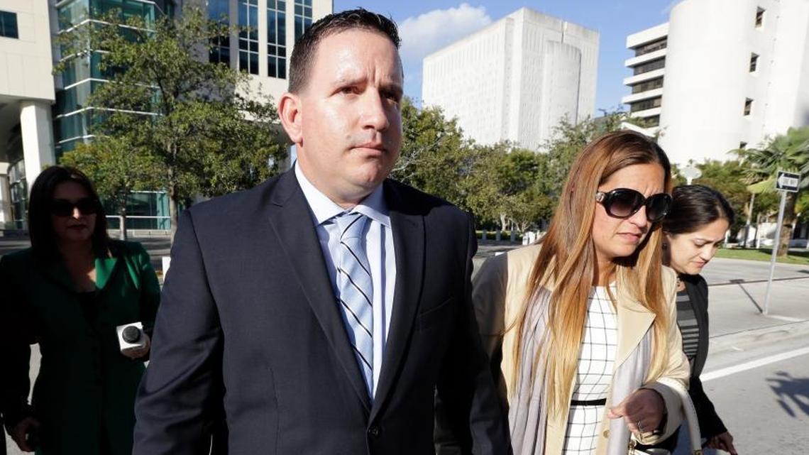 In this Feb. 1, 2017 file photo, trainer Julio Estrada, left, leaves federal court in Miami. A Miami judge on Thursday sentence Estrada and agent Bart Hernandez each to prison for their role in smuggling Cuban baseball players into the United States.