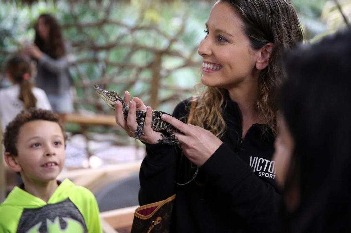 Jayden Cerrato looks at his mom, Kayte Wilson, holding a baby alligator during their visit to the Zoological Wildlife Foundation in southwest Miami-Dade.