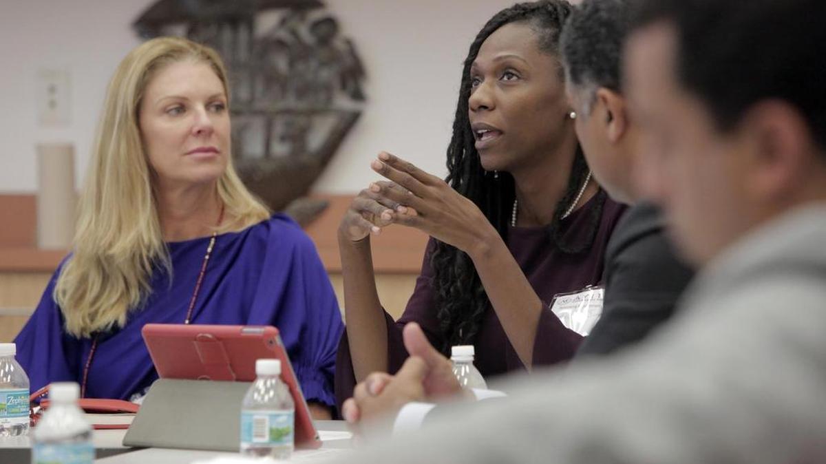 Natacha Janac, center, makes a point as Michele King Soffer, left, looks on during a meeting at the Little Haiti Cultural Center. The Ayiti Community Trust hosted a panel on rethinking Haitian philanthropy.