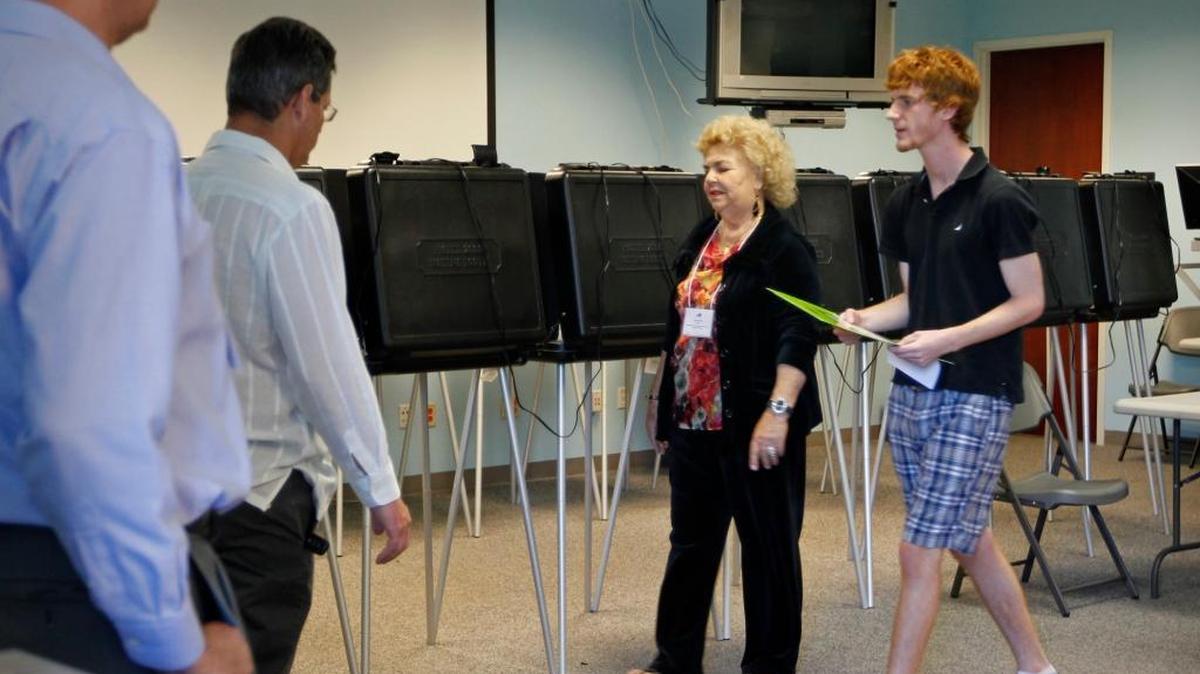 Here’s what it looked like as early voting got underway in the presidential primary 4 years ago. Steven Gonzalez, right, prepares to cast his ballot at the Elections Department in Doral, Jan. 21, 2012.