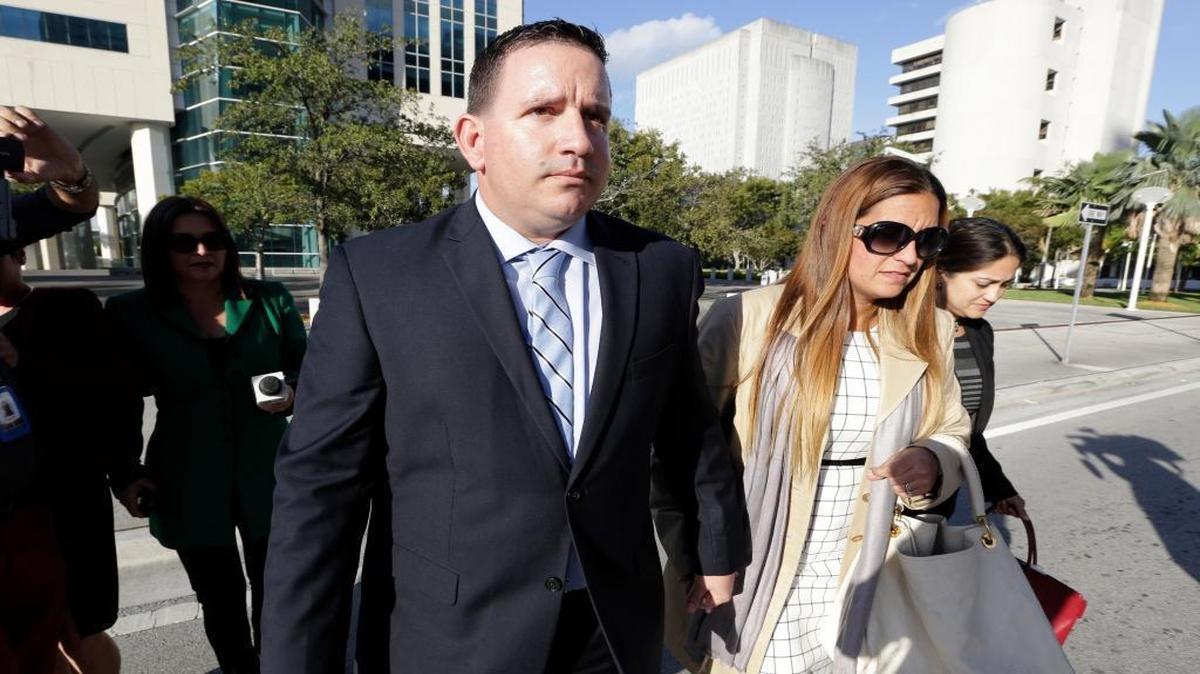 FILE- In this Feb. 1, 2017 file photo, trainer Julio Estrada, left, leaves federal court in Miami. A Miami jury convicted Estrada and agent Bartolo Hernandez on Wednesday, March 15, 2017, on charges they smuggled Cuban baseball players to the U.S. in search of big profits from professional free agent contracts.
