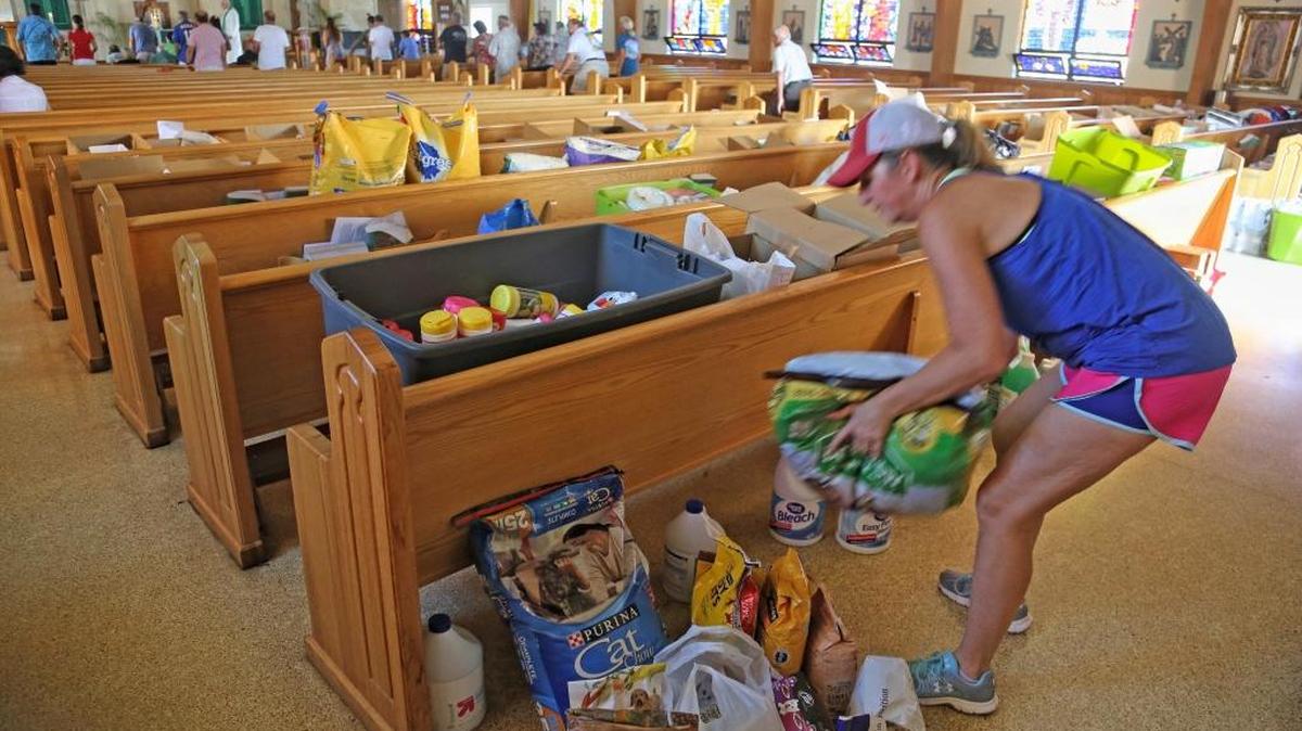 Palm City resident Sandy Burton drops off donated items during Mass at San Pablo Catholic Church on Marathon Key on Sunday. Organizations across South Florida are collecting goods for victims of hurricanes Irma and Maria.