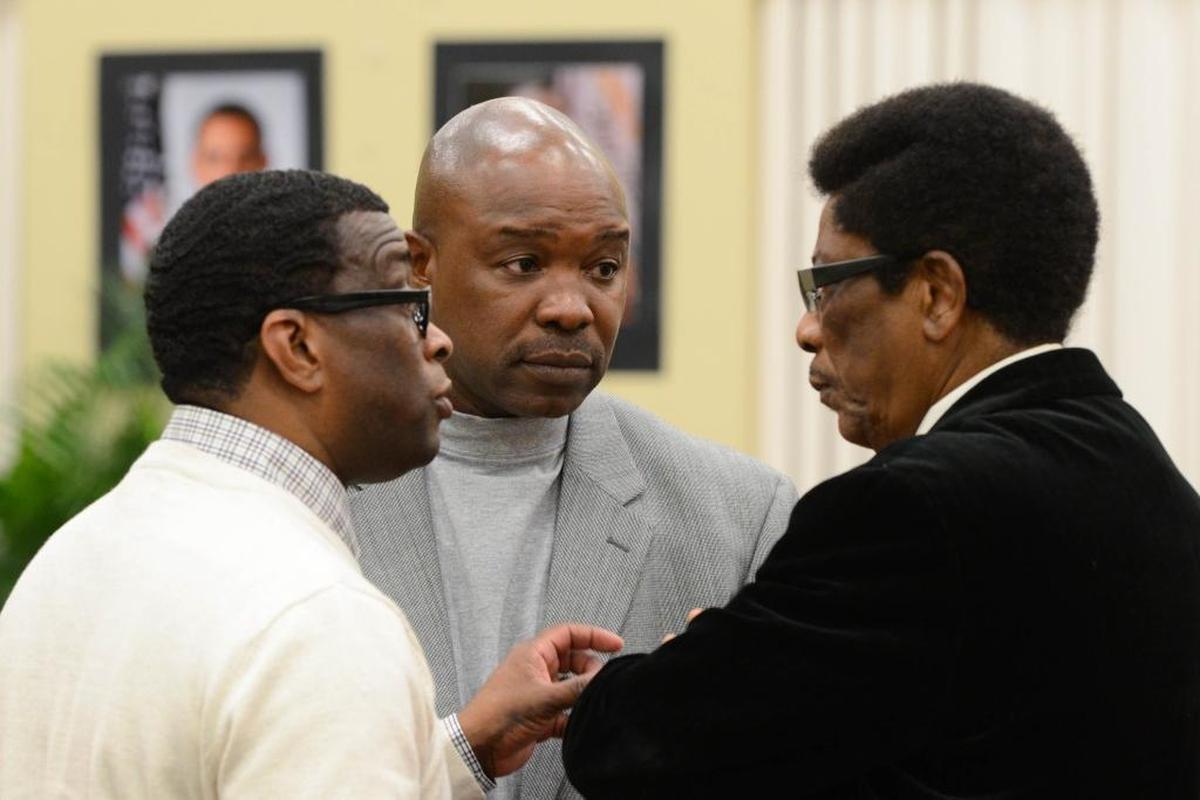 Lobbyist Dante Starks, Budget Director Keith Carswell and Bishop John Taylor, husband of Mayor Myra Taylor, speak after the Opa-locka state of the city address on Friday, Jan. 29, 2016.