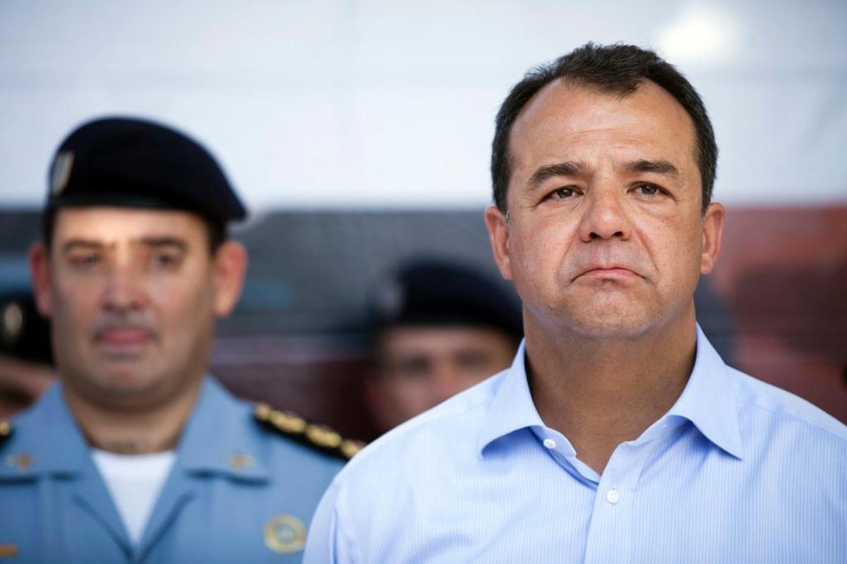 Rio de Janeiro Gov. Sergio Cabral, right, attends a 2012 ceremony in Rio. Cabral was sentenced in June to 14 years and two months in prison for corruption and money laundering. (AP Photo/Victor R. Caivano, File)