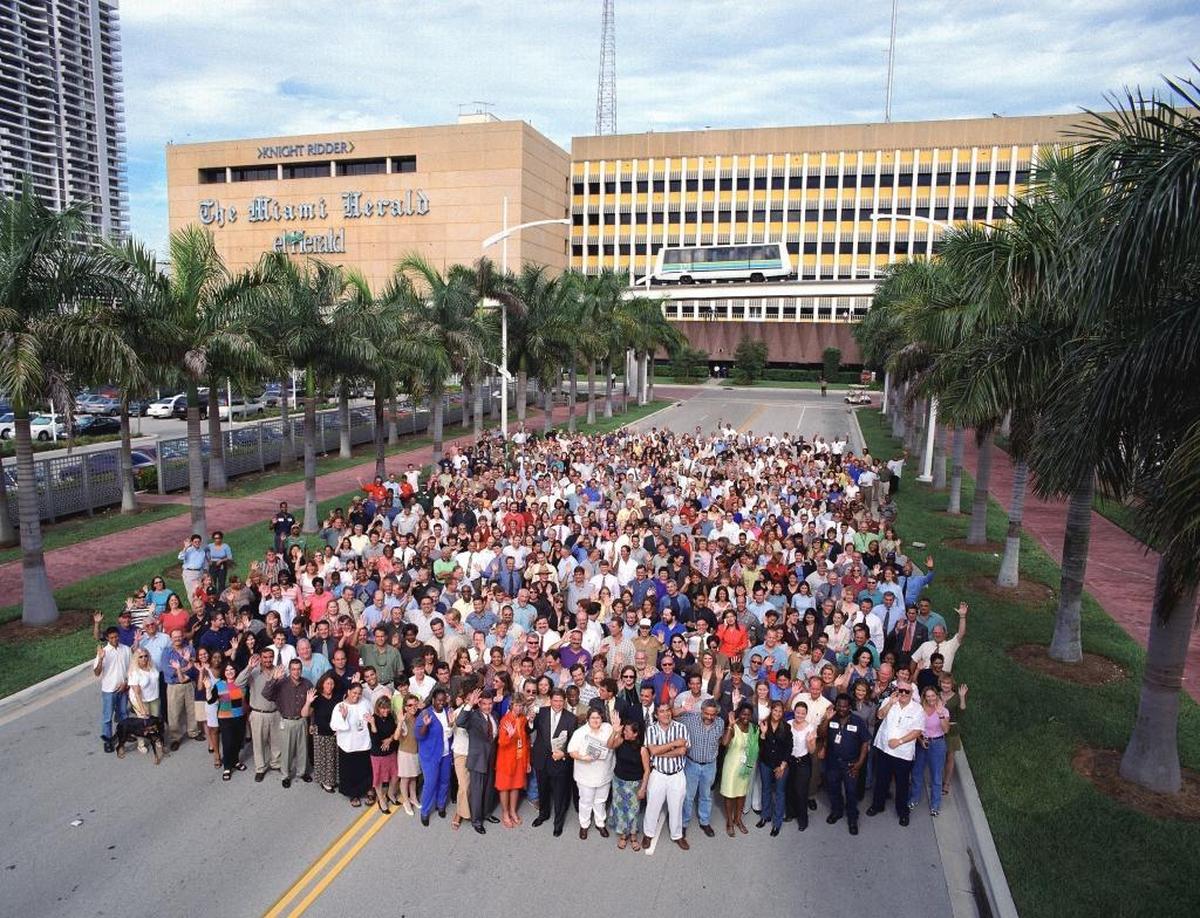 Employees gather outside the former Herald headquarters.
