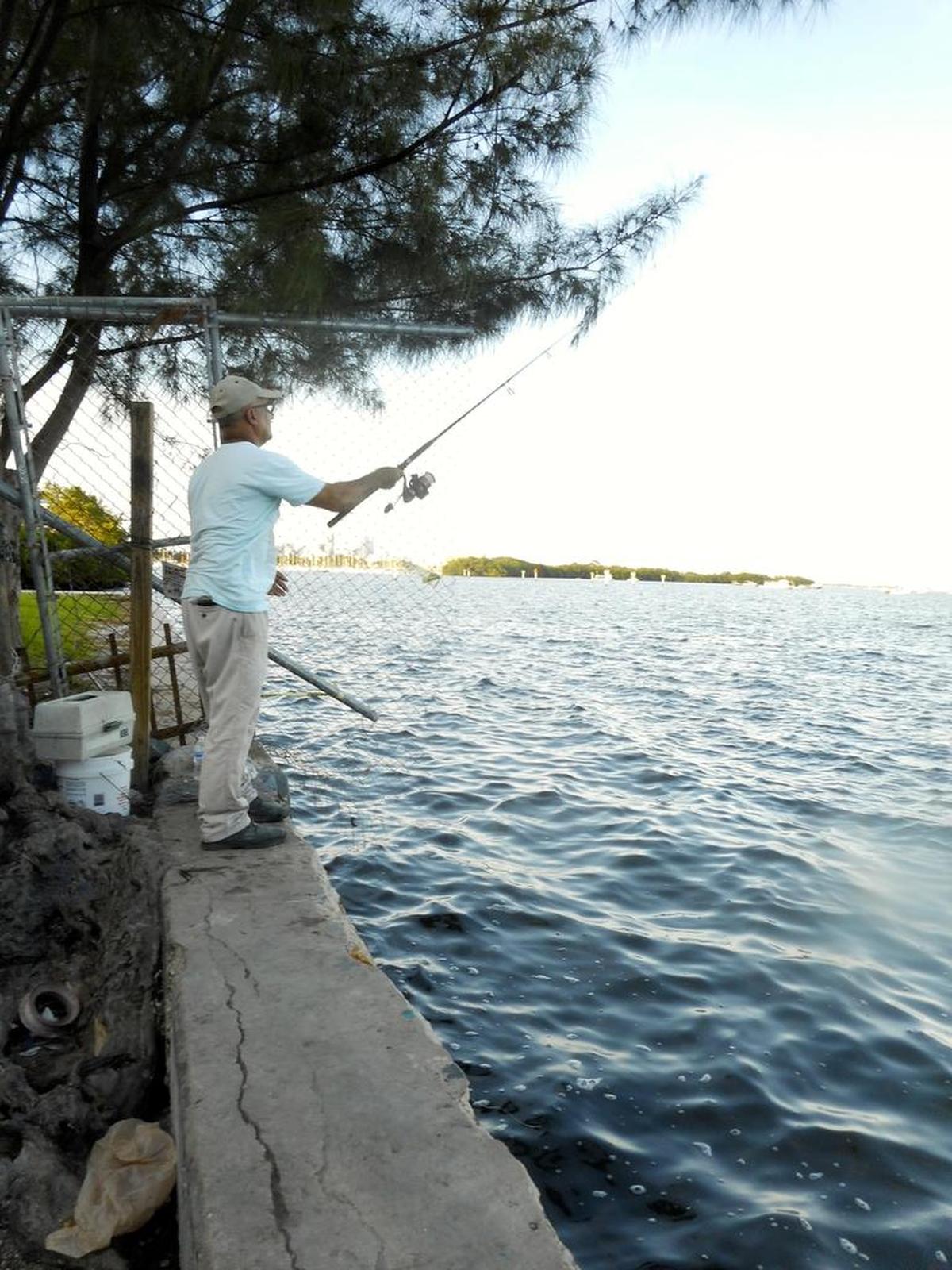 A fisherman casts off the seawall at the end of Royal Road in Coconut Grove, a space to be enhanced after a proposal to beautify it won a Public Space Challenge grant from the Miami Foundation. The Foundation announced the 21 winners on Tuesday, Aug. 29, 2017.
