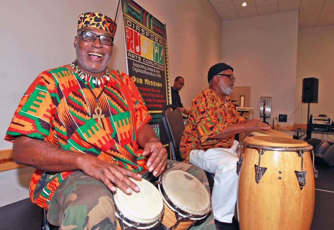 Gregory Amin Norflee and Daniel McCleod play the drums at the Diaspora Arts Coalition’s "Kwanzaa in the Gardens" celebration at the Betty T. Ferguson Recreational Complex Auditorium in Miami Gardens on Monday, Dec. 26, 2016.
