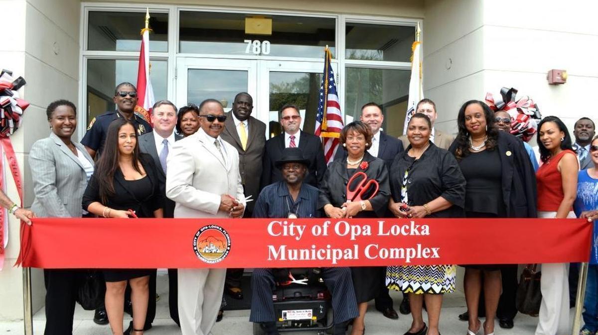 Opa-locka officials celebrate the purchase of the Town Center One building, which was destined to replace the city’s iconic but decaying city hall. It was this past spring, a time when the city had growing debt problems that had not been publicly disclosed