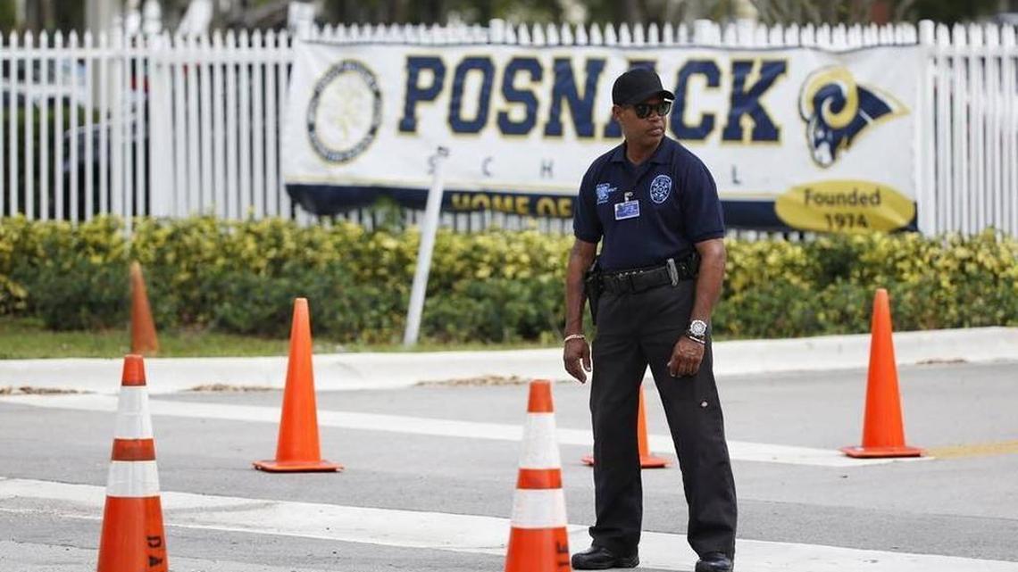 A security guard stands outside the entrance to the David Posnack Jewish Community Center and David Posnack Jewish Day School after people were evacuated because of a bomb threat on Feb. 27, 2017, in Davie. Jewish centers and schools across the nation are coping with another wave of bomb threats as officials in Philadelphia begin raising money to repair and restore hundreds of vandalized headstones at a Jewish cemetery.