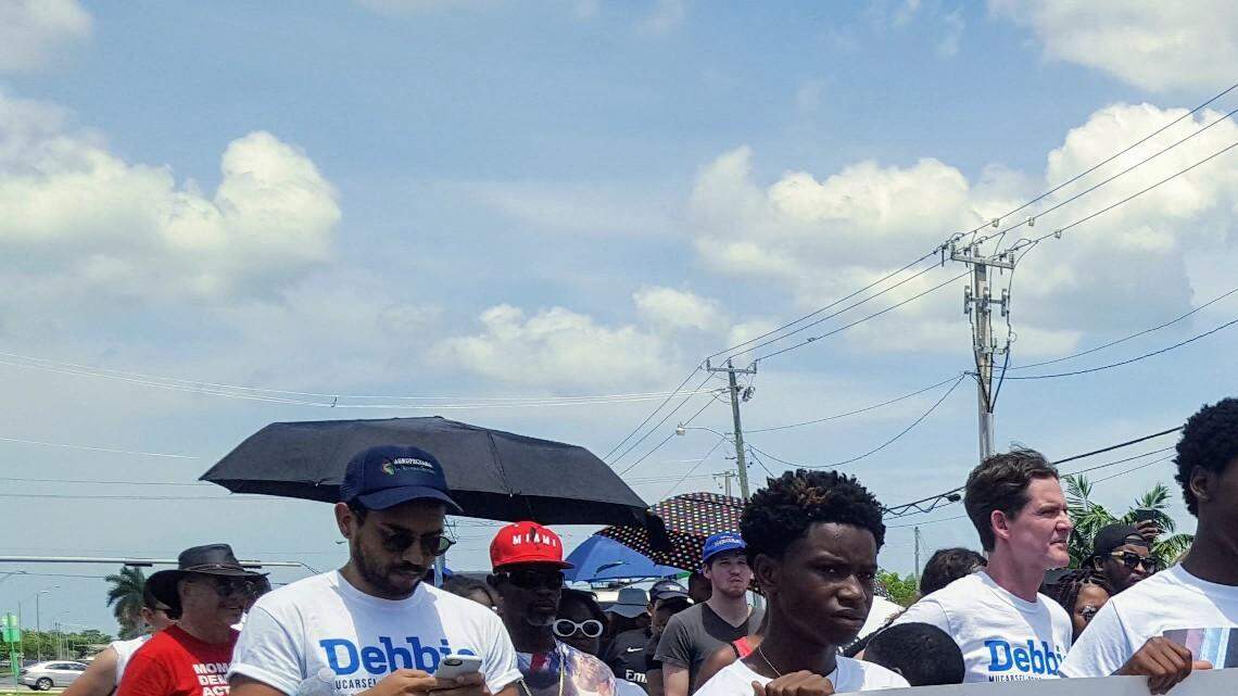 Teens carry a Mothers Fighting for Justice banner during the fourth annual Walk for Justice, held Saturday, July 21, 2018, in Goulds.