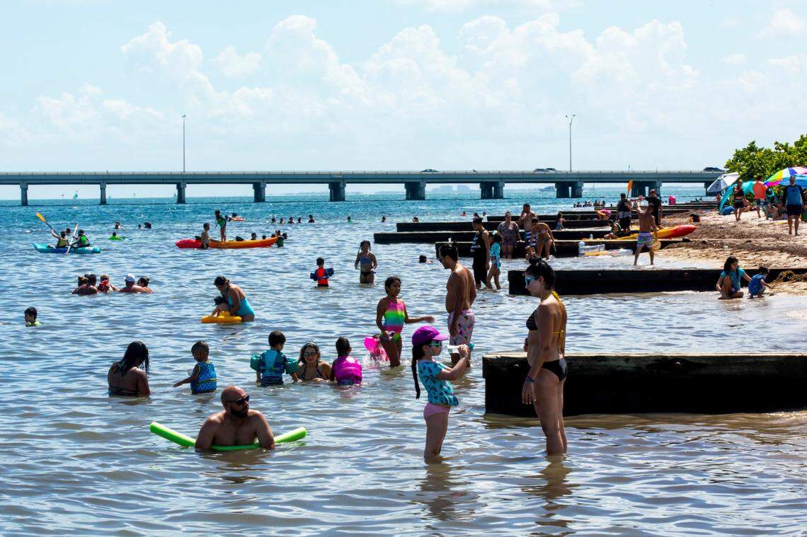 Beachgoers swim during the Historic Virginia Key Beach Park’s 75th Anniversary celebration in Miami-Dade on Aug. 8, 2020.