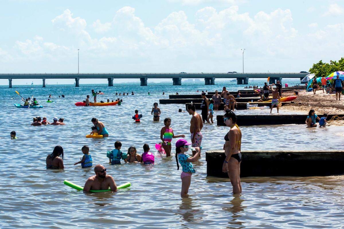 Beachgoers swim during the Historic Virginia Key Beach Park’s 75th Anniversary celebration in Miami-Dade on Aug. 8, 2020. 