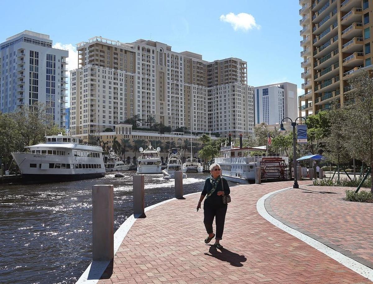 Home purchases by investors in Miami and Fort Lauderdale jumped a whopping 90% in the second quarter of 2021, compared with the same period the year before. Above: A pedestrian strolling down Downtown Fort Lauderdale’s Riverwalk.
